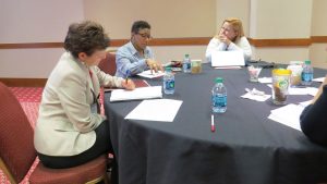 Summit participants share best practices and take notes during small group discussion